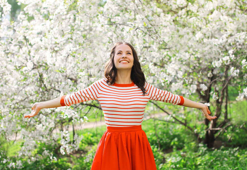 Happy woman outside in a spring garden